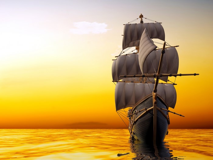 Sailing ship on the sea at sunset