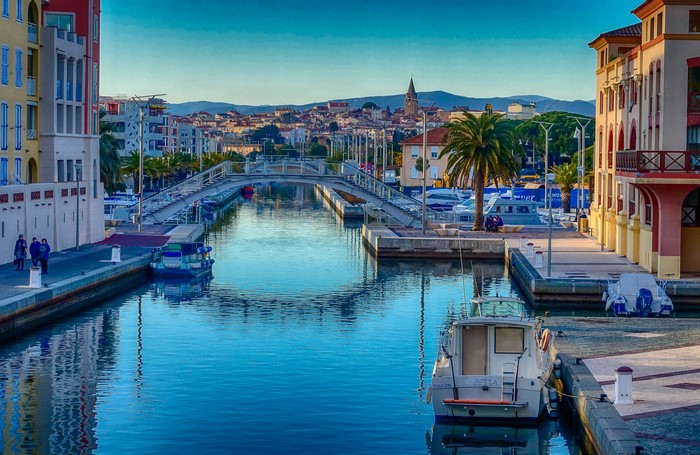 Canal with bridge and boats in France