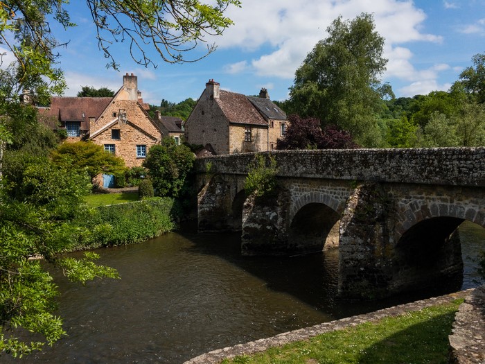 Stone bridge over a river in Saint Ceneri Le Gerei, France