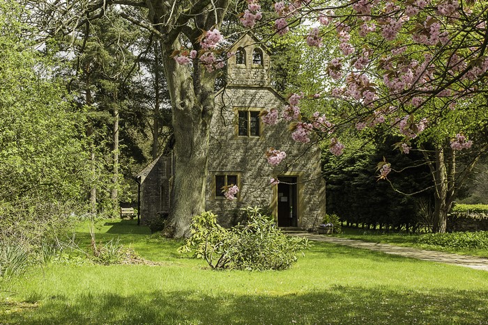 Stone church with flowering trees in England