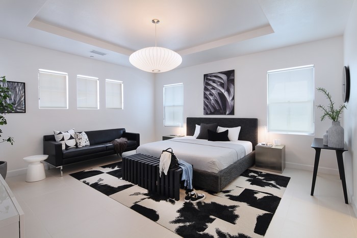 Modern Bedroom with Sofa, Bed, and Abstract Art