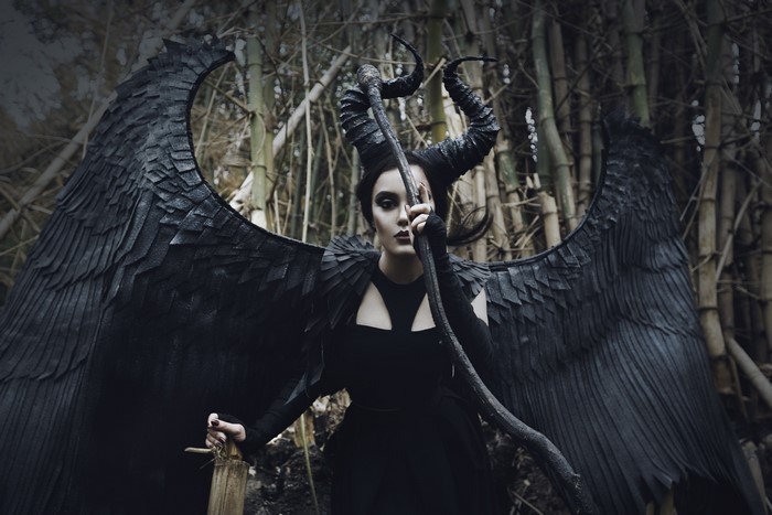 Maleficent cosplay with black wings and horns
