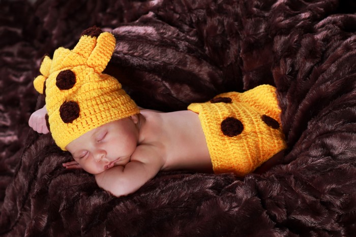 Baby sleeping in giraffe costume