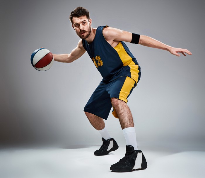 Man in basketball uniform dribbling a ball