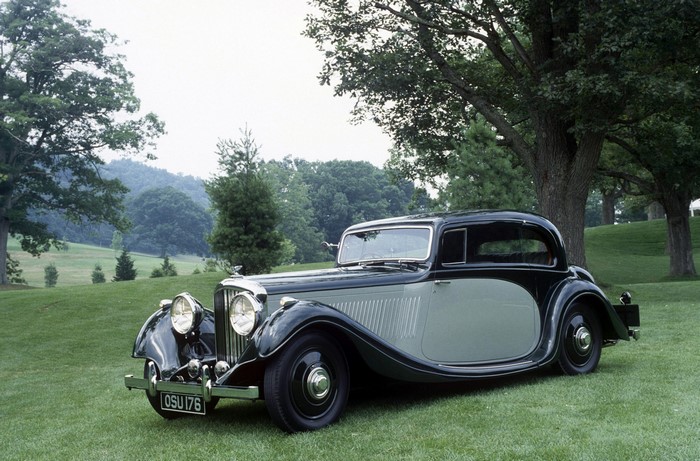 Vintage Bentley car on a grassy hill