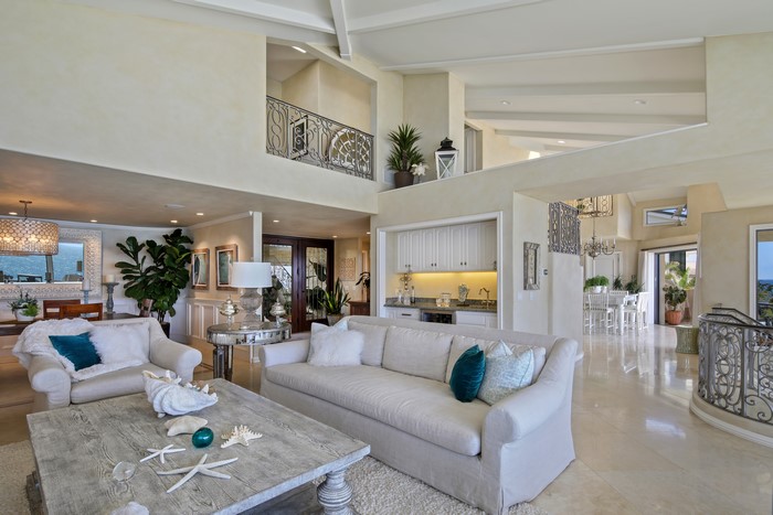Living room with sofas, coffee table, and bar area