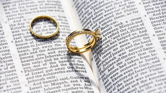 Wedding rings on an open Bible