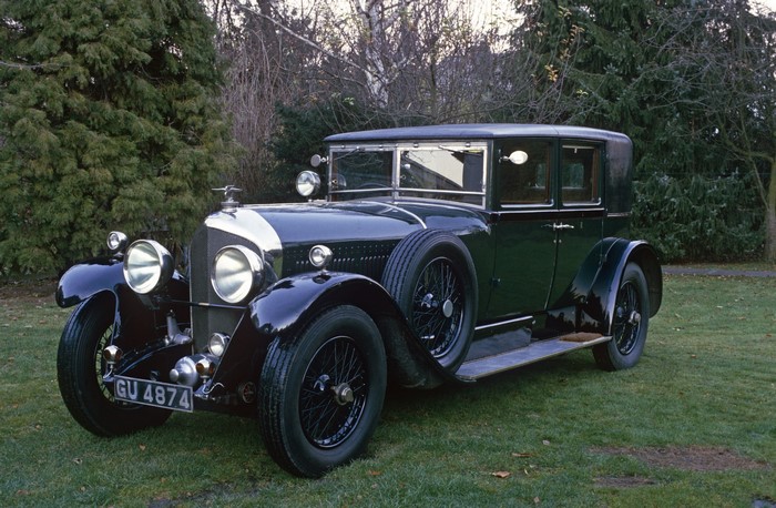 Vintage Bentley car parked on grass