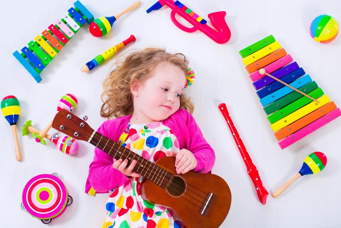 Little girl with musical toys