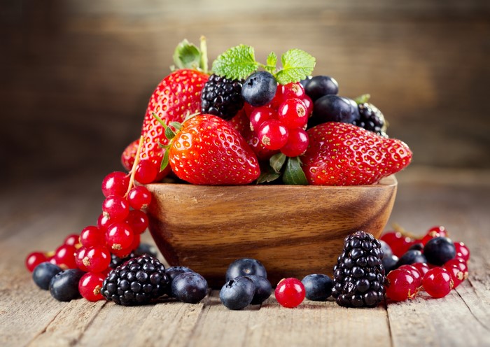 Berries in a wooden bowl with mint