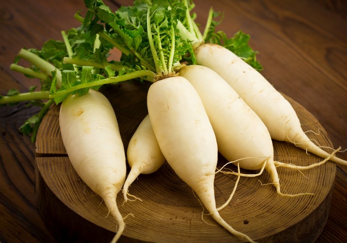 White Radishes on a Wooden Board