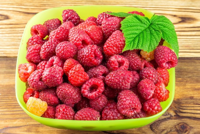 Bowl of Raspberries with Leaf