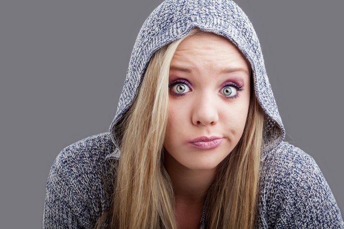 Woman in Hooded Sweatshirt with Surprised Expression