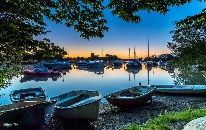 Boats in a harbor at sunset, England
