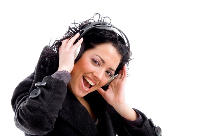 Brunette girl with headphones listening to music