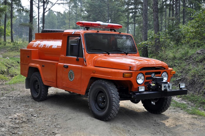 Orange Beijing BJ5042GGS12 fire truck in forest