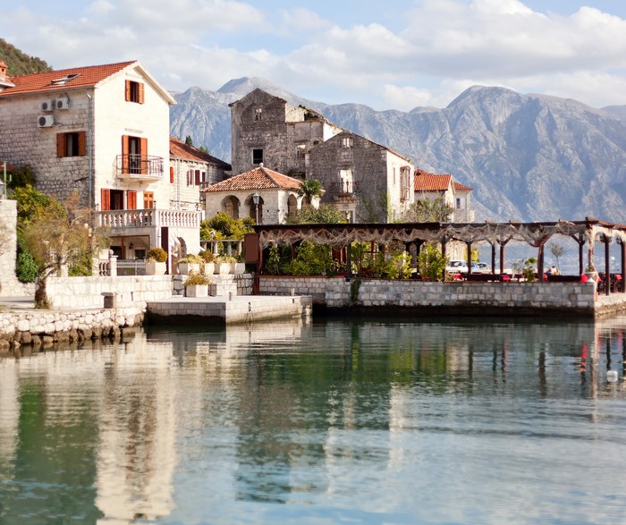 Perast, Montenegro waterfront with stone buildings and mountains
