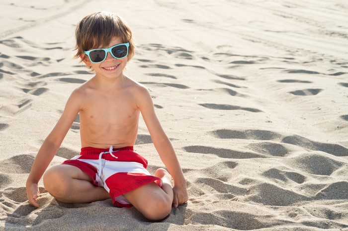 Boy in Sunglasses on Sandy Beach