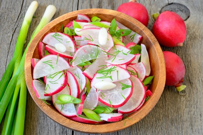 Radish Salad with Scallions and Dill in Wooden Bowl