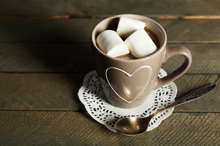 Cup of hot chocolate with marshmallows and spoon