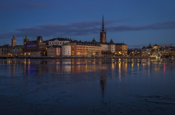 Stockholm skyline at dusk with icy river