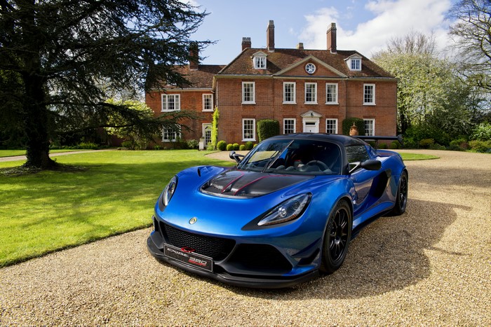 Blue Lotus Exige Cup 380 in front of a mansion