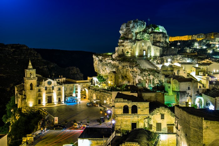Matera, Italy at night with illuminated buildings and rock formations