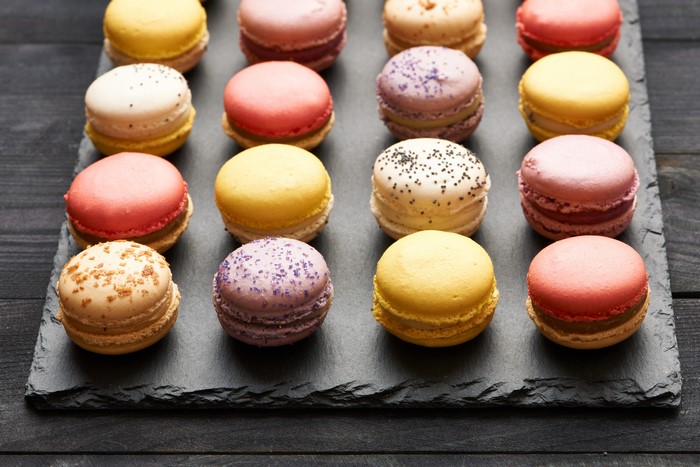 Assortment of colorful macarons on a slate platter