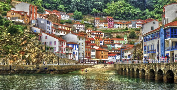 Colorful houses on a hillside overlooking a bay in Cudillero, Spain