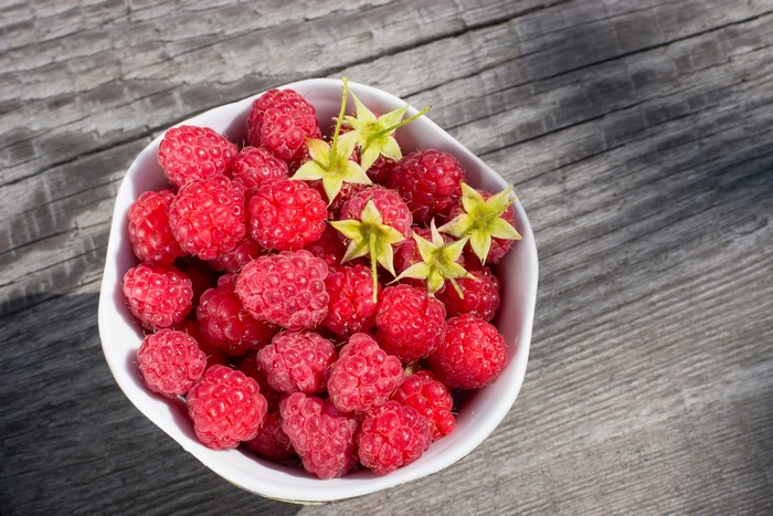 Bowl of Raspberries with Green Stems