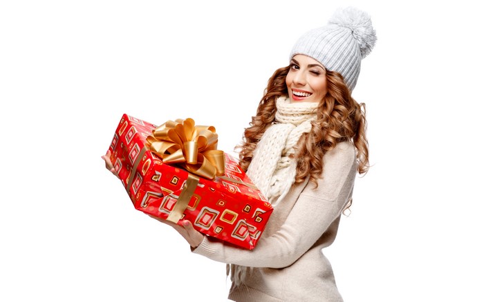 Woman in winter hat holding a gift