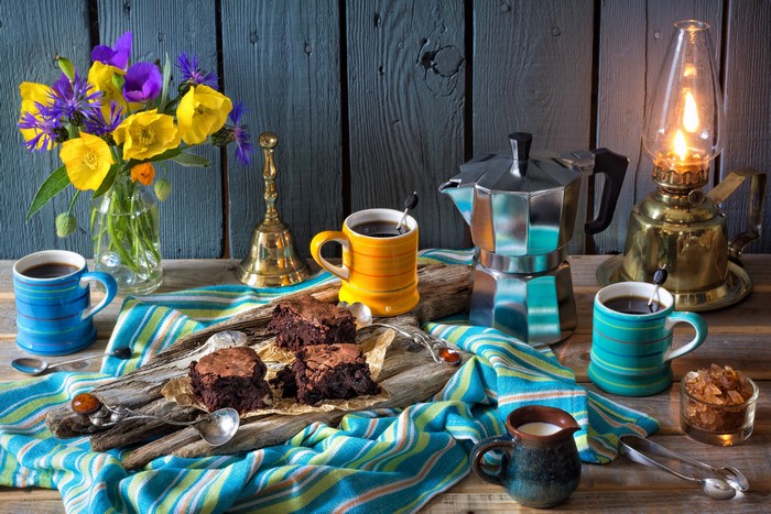 Still-life with coffee, brownies, and flowers