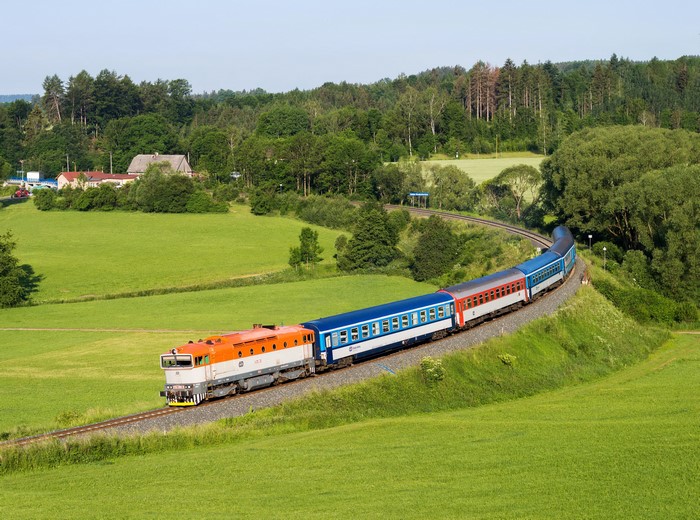 Train traveling through green Czech Republic countryside