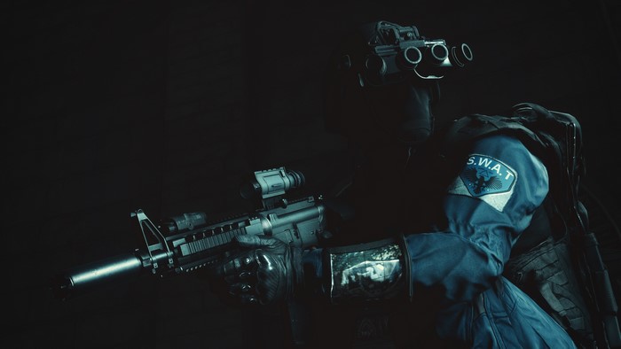 SWAT officer with assault rifle and night vision goggles