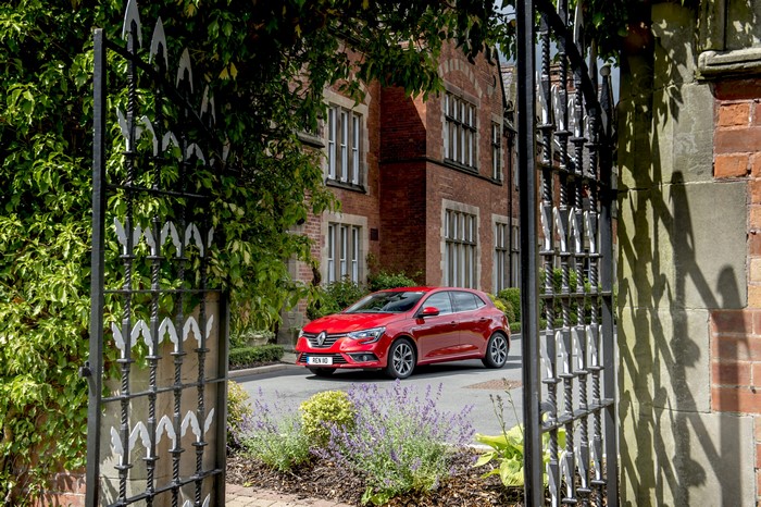 Red Renault Megane GT Line parked outside building
