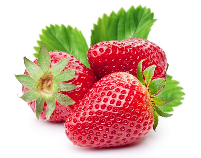 Three Strawberries with Leaves on White Background