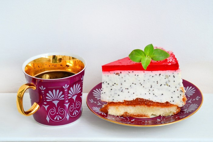 Coffee cup and a slice of cake on a plate