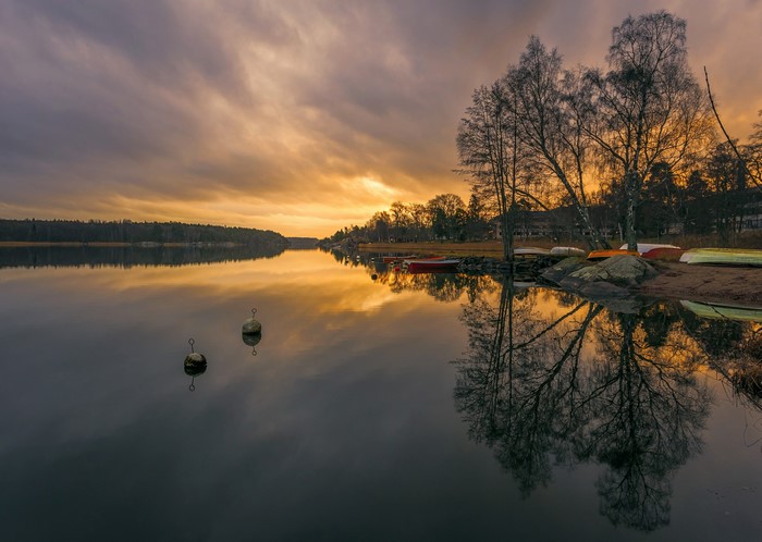 Sunset over a lake in Sweden with boats