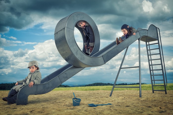 Three girls on a creative playground slide