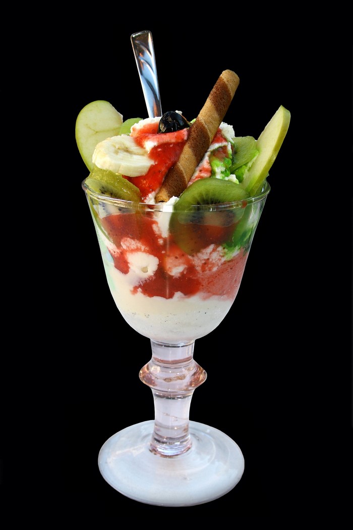 Ice cream sundae with fruits and wafer stick