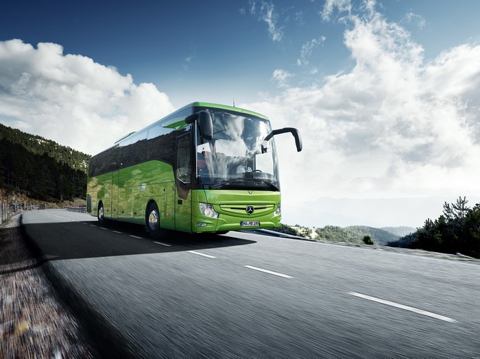 Green Mercedes-Benz Tourismo Bus on a Mountain Road