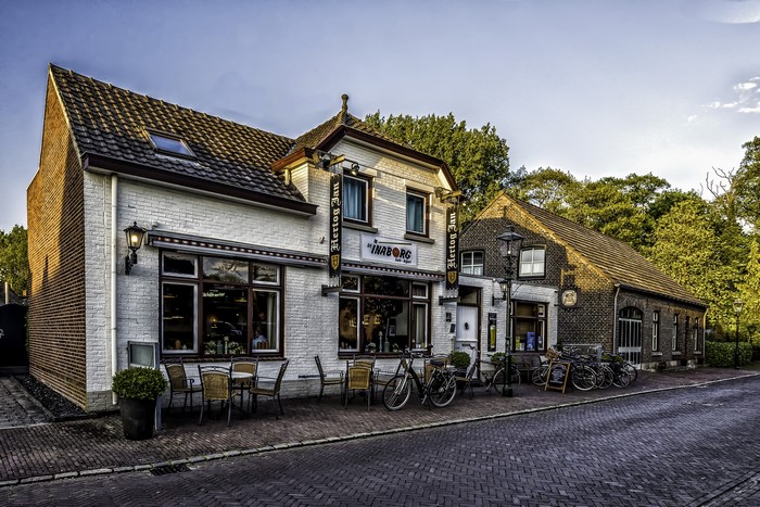 Hertog Jan Inn building with bicycles on street in Arcen, Netherlands