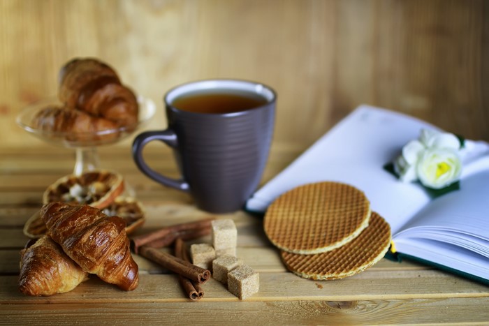 Still life with tea, croissants, cinnamon, and sugar cubes
