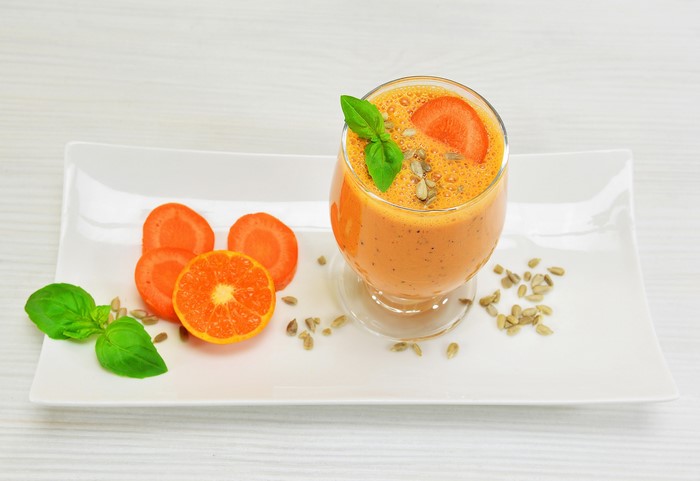 Orange and carrot smoothie with garnishes