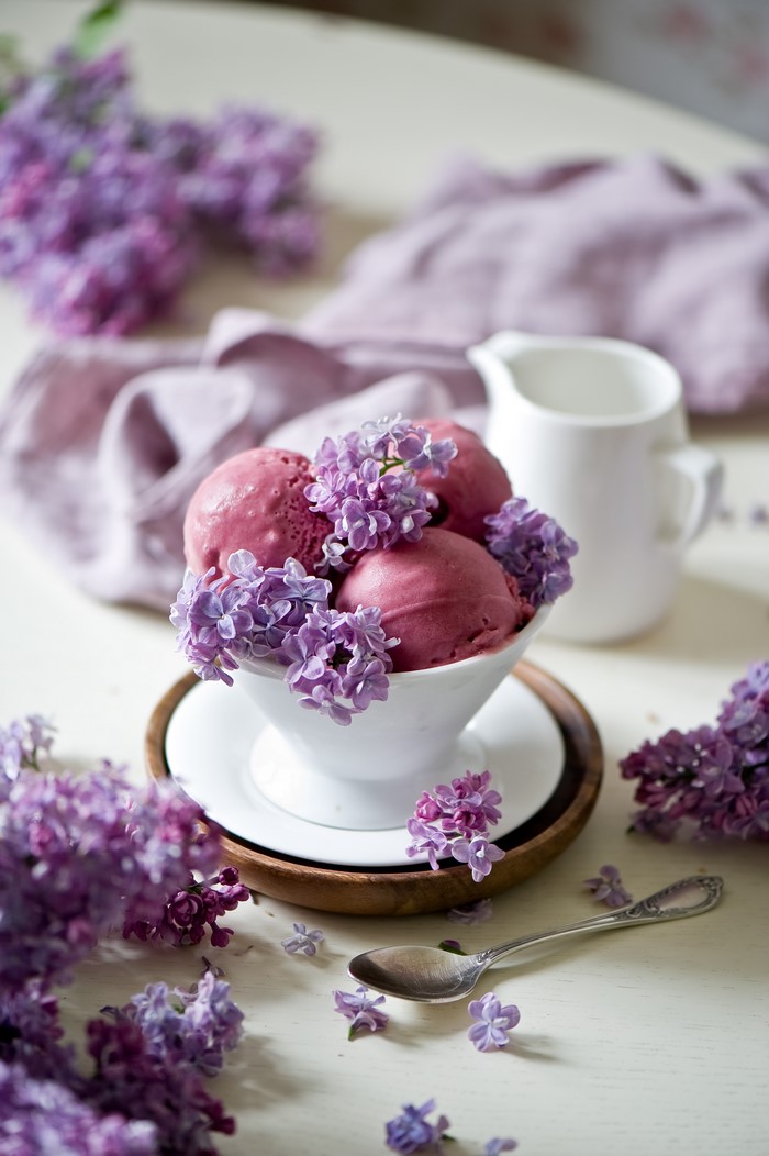 Scoops of berry ice cream with lilac flowers