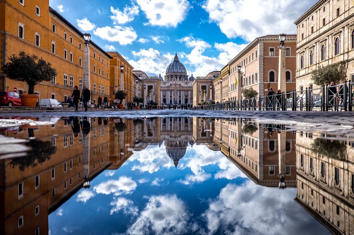 Saint Peter's Basilica reflected in a puddle in Rome, Italy