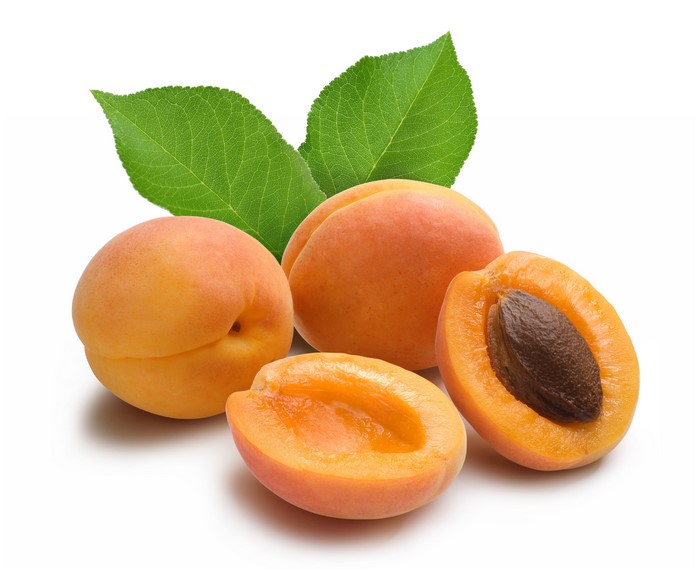 Apricots with leaves on white background