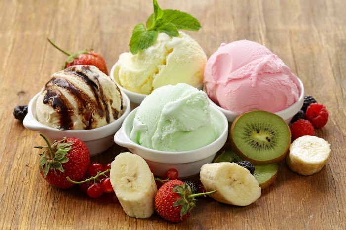 Assortment of ice cream scoops with fresh fruits