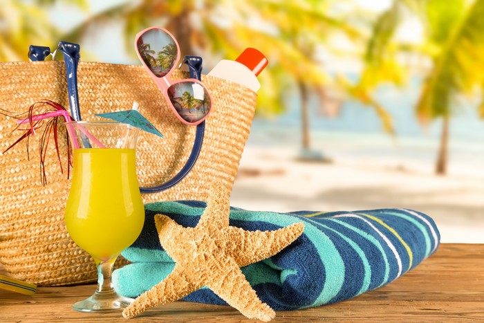 Summer beach accessories with cocktail and starfish