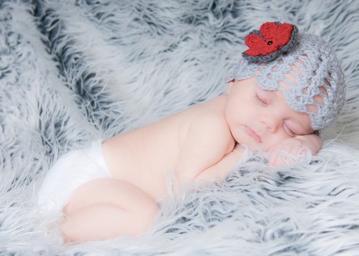 Newborn baby sleeping on a fluffy blanket